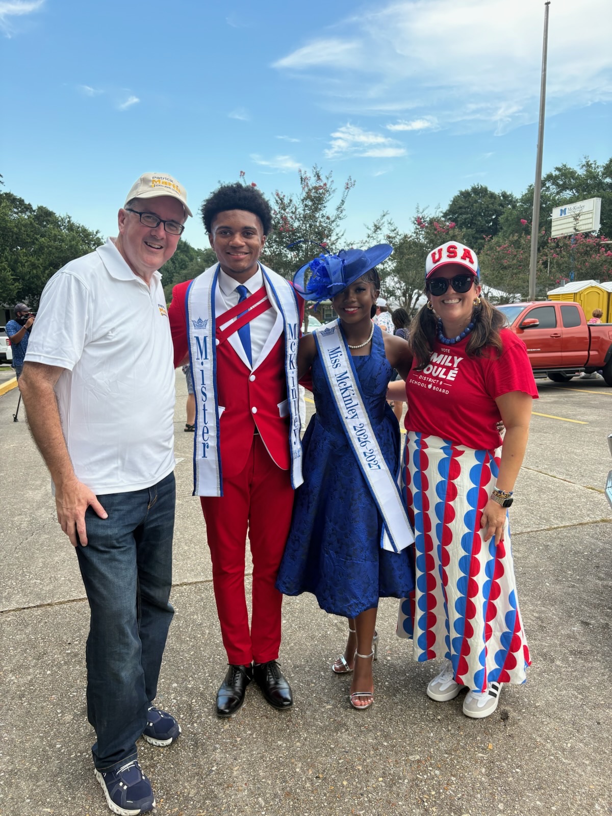 Patrick Martin and Emily Soulé stand with McKinley High's crowned king and queen in their sashes.